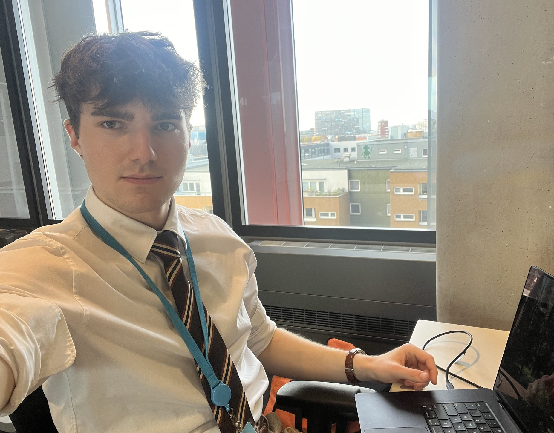 Me sitting at my desk with a shirt and tie on